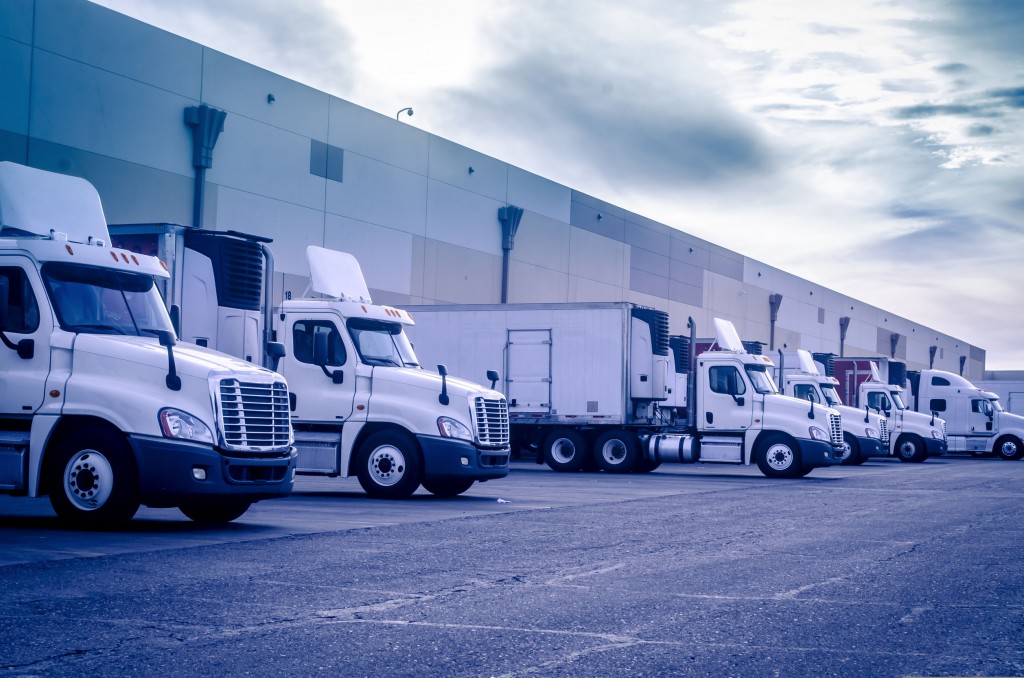 fleet of truck loading at warehouse